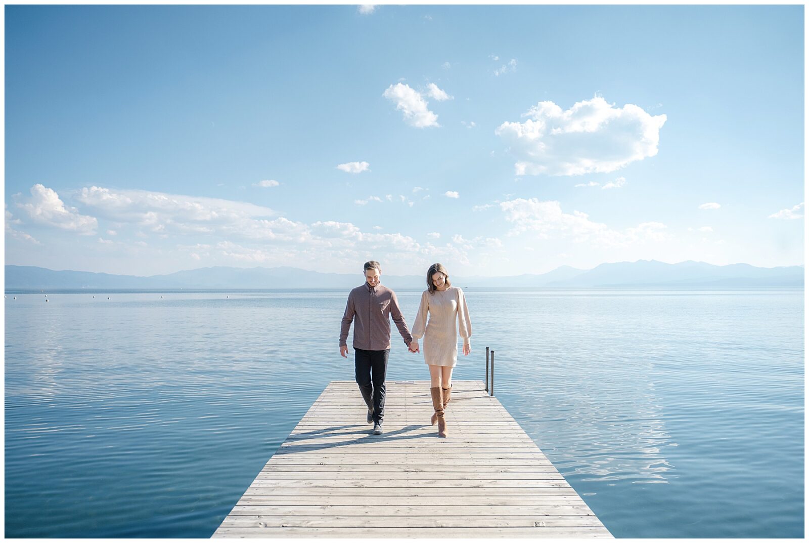 couple walking down dock during their lake tahoe engagement session