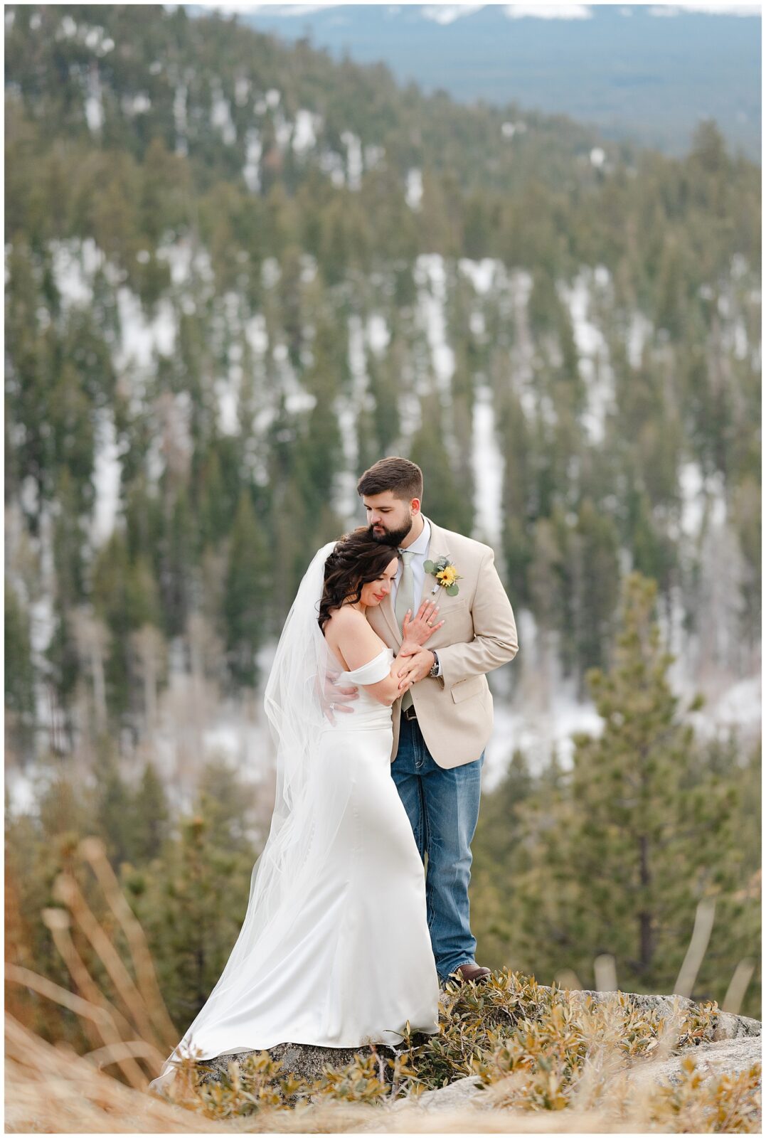 couple at tahoe blue estate up high on a boulder overlooking tahoe