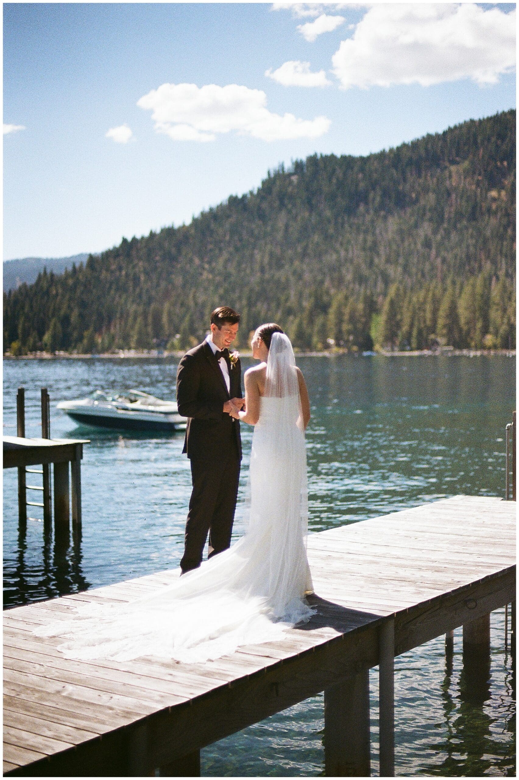 Emotional first look on private pier before Sunnyside Lake Tahoe wedding
